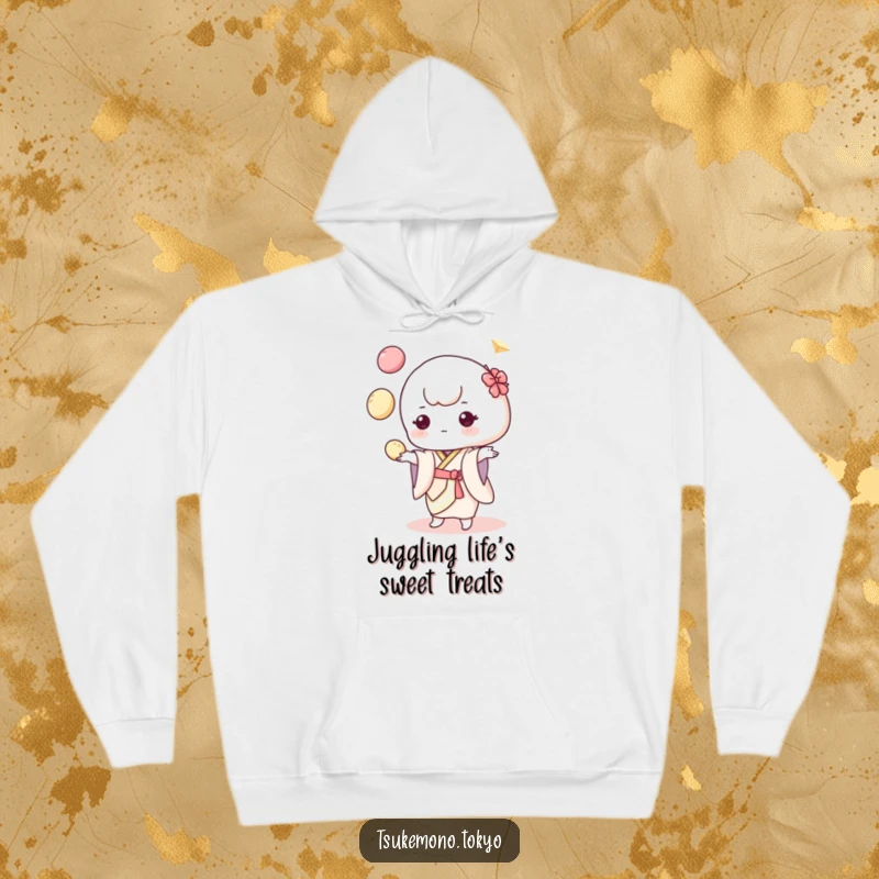 Funny hoodie featuring a delightful mochi character in a pastel kimono, juggling colorful dumplings with an energetic and cheerful pose.